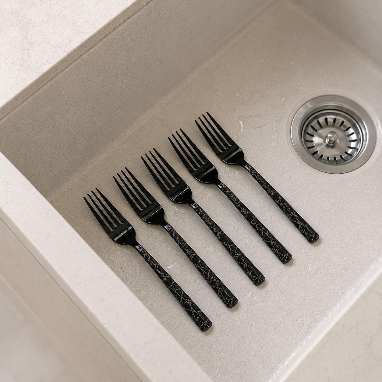 6 black titanium dining forks with laser pattern, suitable for serving food. 4